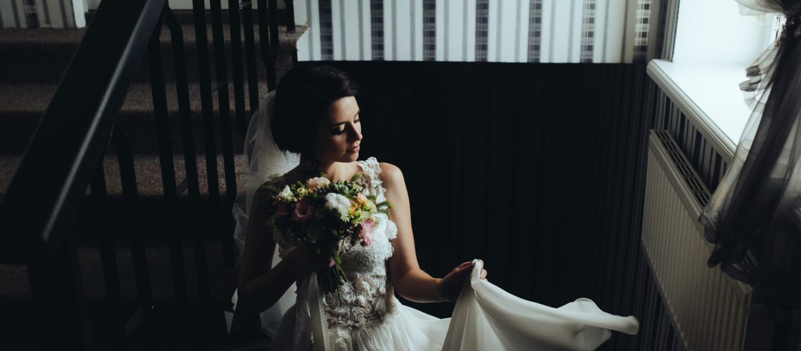 Bride posing on the stairs to the chamber