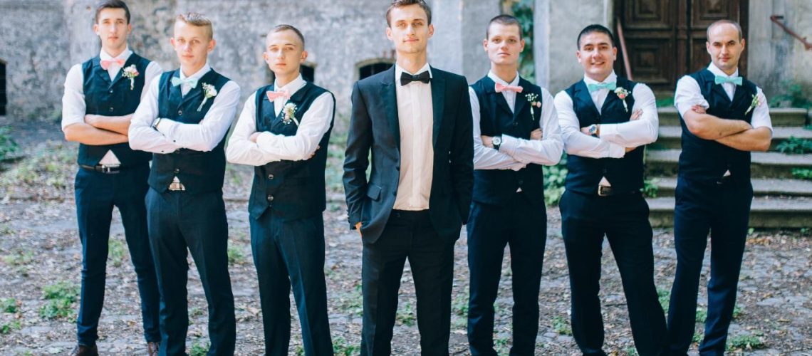 groomsmen-groom-in-front-of-wedding-venue